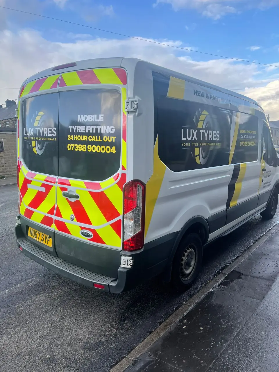 Rear of Lux Tyres mobile fitting van with safety chevrons