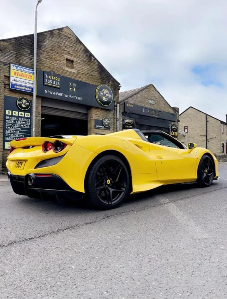 Yellow Ferrari F8 outside Lux Tyres Halifax