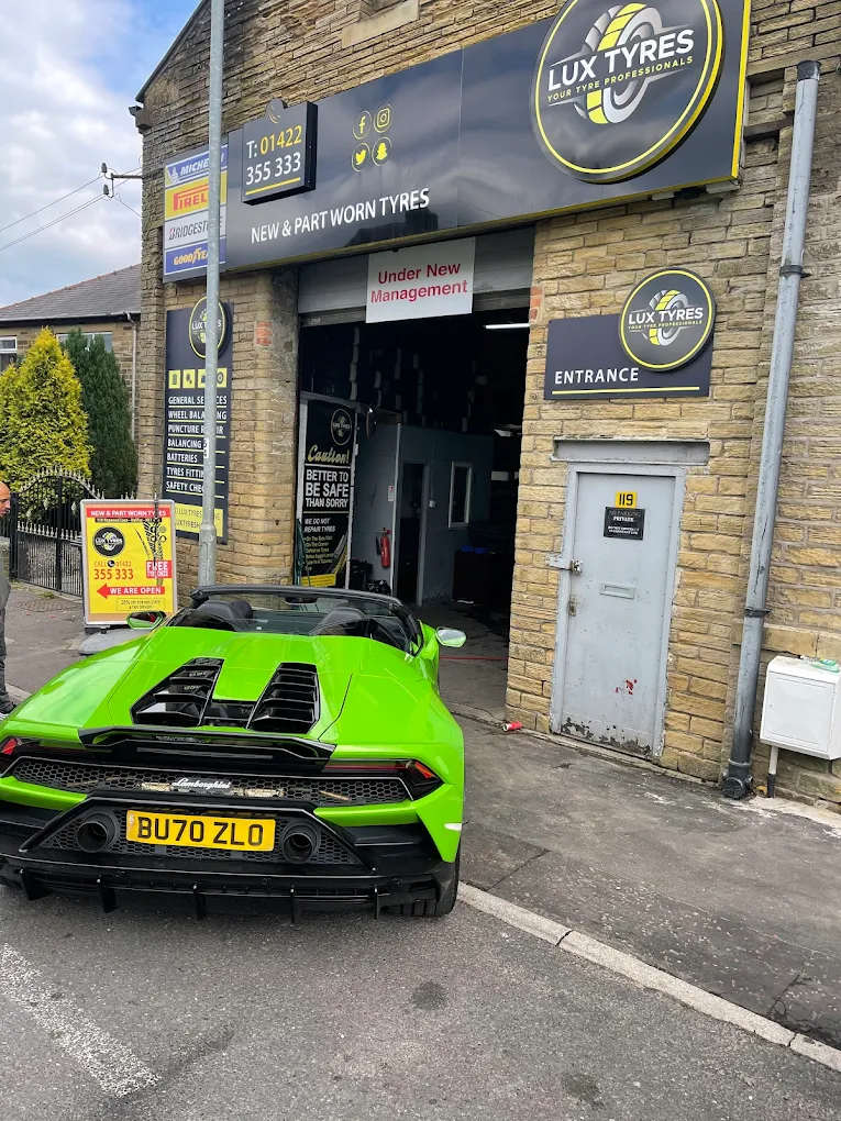 Green Lamborghini Huracán at Lux Tyres entrance